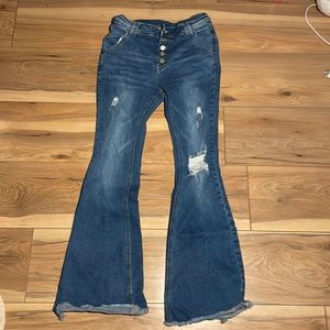 Bell bottom jeans. Holes in the knees. Boutique jeans